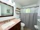 Modern bathroom featuring a vanity with a granite countertop and round decorative shelving at 663 Embry Ln, Marietta, GA 30066