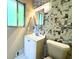 Compact bathroom features a modern vanity, mosaic tile accents, and a window at 663 Embry Ln, Marietta, GA 30066