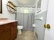 Clean bathroom featuring a modern vanity, decorative shelving, and a shower with a gray curtain at 663 Embry Ln, Marietta, GA 30066