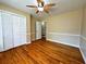 Bedroom featuring hardwood floors, a ceiling fan, and natural light from a window at 663 Embry Ln, Marietta, GA 30066