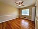 Spacious bedroom featuring hardwood floors, a ceiling fan, and a large window at 663 Embry Ln, Marietta, GA 30066