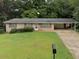 Charming single-story brick home with a well-maintained lawn and covered carport at 663 Embry Ln, Marietta, GA 30066