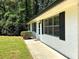 Side view of a renovated single-story home with a well-manicured lawn and modern shutters at 663 Embry Ln, Marietta, GA 30066