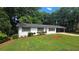Charming home with landscaped yard, black shutters, and covered parking at 663 Embry Ln, Marietta, GA 30066