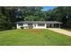 Ranch home featuring black shutters, covered parking, and a well-manicured front lawn at 663 Embry Ln, Marietta, GA 30066