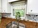Close up on kitchen sink and window showcasing granite counters and mosaic tile backsplash at 663 Embry Ln, Marietta, GA 30066