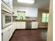 Updated kitchen with white cabinets, stainless steel appliances, and wood flooring at 663 Embry Ln, Marietta, GA 30066