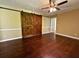 Open living room featuring wood floors and large rustic barn doors at 663 Embry Ln, Marietta, GA 30066