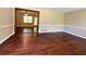 View of the large living room with stunning hardwood floors and view into another room at 663 Embry Ln, Marietta, GA 30066