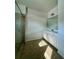 Bathroom features a shower, vanity and tile flooring at 7665 Easton Valley Ln, Cumming, GA 30028