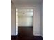 Open doorway leading into a bedroom with wood flooring and neutral paint at 7665 Easton Valley Ln, Cumming, GA 30028