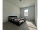 A tidy bedroom with a bed near a window at 7665 Easton Valley Ln, Cumming, GA 30028