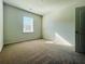 Cozy bedroom with a window for natural light, featuring a neutral carpet at 7665 Easton Valley Ln, Cumming, GA 30028