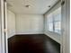 Bright bedroom features dark wood floors and a large window at 7665 Easton Valley Ln, Cumming, GA 30028