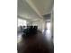 Spacious dining room features wood floors and stylish lighting at 7665 Easton Valley Ln, Cumming, GA 30028