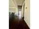 A hallway with wood floors and stairs leading to upper level at 7665 Easton Valley Ln, Cumming, GA 30028