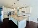 Kitchen with granite countertops, white cabinets, and stainless steel appliances at 7665 Easton Valley Ln, Cumming, GA 30028