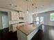 Kitchen with granite countertops, white cabinets, and stainless steel appliances at 7665 Easton Valley Ln, Cumming, GA 30028