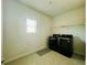 Clean laundry room with modern appliances and tile floors at 7665 Easton Valley Ln, Cumming, GA 30028