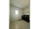 Well-lit laundry room equipped with modern appliances and tile floors at 7665 Easton Valley Ln, Cumming, GA 30028