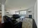 Bright living room featuring a fireplace, hardwood floors, and large windows at 7665 Easton Valley Ln, Cumming, GA 30028
