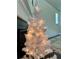 A decorative lighted tree in front of a living room space at 7665 Easton Valley Ln, Cumming, GA 30028