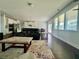 Open living room and kitchen with dark wood floors at 7665 Easton Valley Ln, Cumming, GA 30028