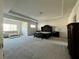 Large main bedroom featuring plush carpet, sitting area, and elegant furnishings at 7665 Easton Valley Ln, Cumming, GA 30028