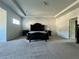 Spacious main bedroom with tray ceiling, plush carpet, and elegant furnishings at 7665 Easton Valley Ln, Cumming, GA 30028
