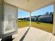 Covered patio with a view of the lush green lawn and surrounding homes at 7665 Easton Valley Ln, Cumming, GA 30028