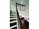 Staircase leading to a living area with hardwood floors, a fireplace, and ample natural light at 7665 Easton Valley Ln, Cumming, GA 30028
