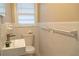 Bright bathroom featuring white fixtures, tile walls, and natural light at 8424 Taylor Rd, Riverdale, GA 30274