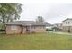 Charming brick home featuring a well-maintained lawn and convenient covered carport at 8424 Taylor Rd, Riverdale, GA 30274