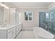 Bathroom boasts double vanity, soaking tub, tiled shower and marble flooring at 3812 Havenrock Dr, Marietta, GA 30066