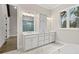 Bathroom featuring double vanity, linen closet, tiled shower, and marble flooring at 3812 Havenrock Dr, Marietta, GA 30066