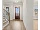 Bright foyer with hardwood floors, wood staircase, and large front door with transom window at 3812 Havenrock Dr, Marietta, GA 30066