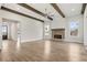Expansive living room featuring hardwood floors, brick fireplace, beamed ceilings, and open floorplan at 3812 Havenrock Dr, Marietta, GA 30066
