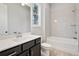 Modern bathroom featuring a vanity with dark cabinets, white countertop, and a tiled tub-shower combo at 3816 Havenrock Drive, Marietta, GA 30066