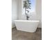 Bright bathroom with a freestanding tub, marble tile backsplash, dark fixtures, and a large window at 3816 Havenrock Drive, Marietta, GA 30066