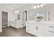 Modern bathroom with double sink vanity, sleek fixtures, tile floor, and marble shower at 3816 Havenrock Drive, Marietta, GA 30066