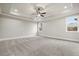 Large bedroom with plush carpet flooring, tray ceiling with fan, recessed lights, and many windows at 3816 Havenrock Drive, Marietta, GA 30066