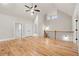 Spacious bonus room featuring beautiful hardwood floors, vaulted ceilings, and a modern ceiling fan at 3816 Havenrock Drive, Marietta, GA 30066