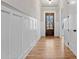 Light and airy foyer with hardwood flooring, wainscoting, and glass paneled front door at 3816 Havenrock Drive, Marietta, GA 30066