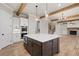 Island kitchen featuring a large island with wood cabinets, modern lighting, and hardwood floors at 3816 Havenrock Drive, Marietta, GA 30066