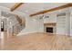 Open living room with hardwood floors, fireplace, and staircase with iron spindles at 3816 Havenrock Drive, Marietta, GA 30066