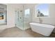 Bright bathroom featuring a glass enclosed walk-in shower and modern soaking tub with tile surround at 3819 Havenrock Dr, Marietta, GA 30066