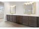 Bathroom with a double vanity featuring dark cabinets, light countertops and modern gold-tone hardware at 3819 Havenrock Dr, Marietta, GA 30066