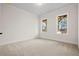 Empty bedroom with carpet, white walls, and natural light from the two windows at 3819 Havenrock Dr, Marietta, GA 30066