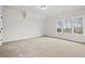 Bright, open bedroom featuring neutral carpet, white walls, and ample natural light from large windows at 3819 Havenrock Dr, Marietta, GA 30066
