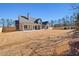 Spacious backyard view of home, showcasing patio, ample land and fenced perimeter at 3819 Havenrock Dr, Marietta, GA 30066